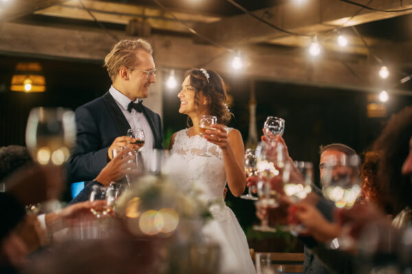 A couple toasting with guests at their wedding. wedding menu ideas